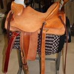 Wade -rough-out seat,fenders,and skirts,straight-back cantle,mule hide wrap,stirrup leathers out and tooled,rawhide oxbows,corner Santa Fe Diamond,s-swirl w channels,floral conchos