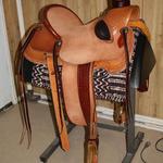 Wade -roughout seat and fenders,Santa Fe Diamond w channels,s-swirl border,basket weave jockey and front,bucking rolls,tooled stirrup leathers,latigo horn wrap,two-tone
