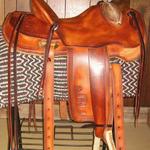 Wade - brand on fenders and jockey, straight-back, mule hide, bucking rolls, oxbows, barbed wire w scallop border, star conchos, rawhide front