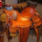 Wade - bucking rolls, mule hide, straight-back, basket wv border, leathers out, floral conchos (1)