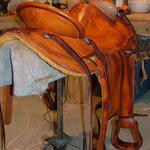 Wade - bucking rolls, mule hide, straight-back, basket wv border, leathers out, floral conchos (2)